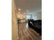 Modern living room with wood-look flooring, granite counters, stainless appliances, and dark sectional sofa at 3558 Eagle Court, Fulton, GA 30331