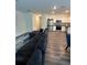 Inviting living space with a large sectional sofa, seamlessly connected to the kitchen and dining areas at 3558 Eagle Court, Fulton, GA 30331
