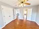 Bedroom with hardwood floors, ceiling fan, light gray walls and white doors at 505 Tilbury Dr, Suwanee, GA 30024