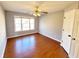 Bedroom with hardwood floors, a ceiling fan, and natural light from a window at 505 Tilbury Dr, Suwanee, GA 30024