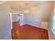 Lofted bedroom with hardwood floors, chandelier and double glass pane doors at 505 Tilbury Dr, Suwanee, GA 30024