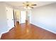 A bedroom with an ensuite bathroom, hardwood floors, a ceiling fan, and a walk-in closet at 505 Tilbury Dr, Suwanee, GA 30024