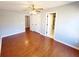 Hardwood floors in a bedroom with a ceiling fan and ensuite bathroom access at 505 Tilbury Dr, Suwanee, GA 30024