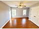 Bright bedroom features hardwood floors, neutral walls, a ceiling fan, and two windows at 505 Tilbury Dr, Suwanee, GA 30024