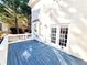 Charming blue painted outdoor deck space with white railings, overlooking backyard and house at 505 Tilbury Dr, Suwanee, GA 30024