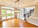 Well-lit dining room featuring hardwood floors, a modern chandelier, and large windows at 505 Tilbury Dr, Suwanee, GA 30024