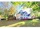 Beautiful home with a well-manicured lawn, blue shutters, and flowering shrubs at 505 Tilbury Dr, Suwanee, GA 30024