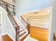 Inviting home foyer with a staircase featuring dark iron, and hardwood and a view of the dining room at 505 Tilbury Dr, Suwanee, GA 30024