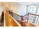 Second story hallway with hardwood floors and decorative metal railings at 505 Tilbury Dr, Suwanee, GA 30024