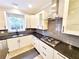 Updated kitchen featuring stainless steel appliances, custom cabinets, and a granite countertop workspace at 505 Tilbury Dr, Suwanee, GA 30024