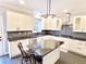Well-equipped kitchen with granite countertops, stainless steel appliances, white cabinets, and a functional island at 505 Tilbury Dr, Suwanee, GA 30024