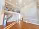 Spacious living room featuring hardwood floors, staircase, and elegant chandelier at 505 Tilbury Dr, Suwanee, GA 30024