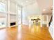 Bright living room with high ceilings, fireplace, large windows, and hardwood floors that connect to the open kitchen at 505 Tilbury Dr, Suwanee, GA 30024