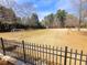 Community soccer field with fencing, set among mature trees under a blue sky at 505 Tilbury Dr, Suwanee, GA 30024
