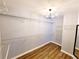 A walk-in closet featuring wire shelving, hardwood floors, and a chandelier at 505 Tilbury Dr, Suwanee, GA 30024
