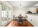 Bright dining area with hardwood floors, modern lighting, and view to outdoor patio creating a seamless indoor/outdoor feel at 6901 Gallant Se Cir # 13, Mableton, GA 30126