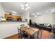 Dining area with wood table, chairs and lighting fixture next to a view into the living room at 6901 Gallant Se Cir # 13, Mableton, GA 30126