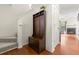 Warm entryway featuring hardwood floors, stairs, coat rack, and access to the main living area at 6901 Gallant Se Cir # 13, Mableton, GA 30126