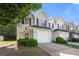 Charming townhome featuring a one-car garage, manicured landscaping, and neutral siding for a welcoming curb appeal at 6901 Gallant Se Cir # 13, Mableton, GA 30126