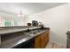 Kitchen featuring granite countertops, wood cabinets, stainless steel sink and a view of the living room at 6901 Gallant Se Cir # 13, Mableton, GA 30126