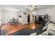 Spacious living area featuring hardwood floors, a cozy seating area, and seamlessly connects to the dining and kitchen spaces at 6901 Gallant Se Cir # 13, Mableton, GA 30126