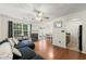 Open-concept living area with hardwood floors, a cozy fireplace, and access to both the kitchen and dining areas at 6901 Gallant Se Cir # 13, Mableton, GA 30126