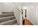 Carpeted staircase leading to the upper level of the home, with access to the laundry room at 6901 Gallant Se Cir # 13, Mableton, GA 30126