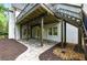 View of backyard, stone patio, and wood deck with stairs leading up to the main deck at 12230 Asbury Park Dr, Roswell, GA 30075