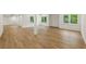 Wide finished basement with wood laminated flooring, recessed lighting and support beam at 12230 Asbury Park Dr, Roswell, GA 30075