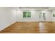 View of basement with wood laminated flooring, and white walls at 12230 Asbury Park Dr, Roswell, GA 30075