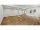 Finished basement with wood laminated flooring, recessed lighting, and support beam at 12230 Asbury Park Dr, Roswell, GA 30075