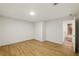 An empty finished basement and wood laminated flooring at 12230 Asbury Park Dr, Roswell, GA 30075