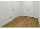 Basement with two white doors and wood laminated flooring at 12230 Asbury Park Dr, Roswell, GA 30075