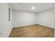 Empty room with wood laminate flooring and white walls at 12230 Asbury Park Dr, Roswell, GA 30075