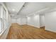 Finished basement features wood laminated flooring, recessed lighting and white trim at 12230 Asbury Park Dr, Roswell, GA 30075
