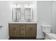 Contemporary bathroom showcasing double vanity sinks, stylish mirrors, and modern fixtures for a sleek design at 12230 Asbury Park Dr, Roswell, GA 30075