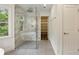 Modern bathroom featuring a glass-enclosed shower, stylish tile work, and access to a walk-in closet at 12230 Asbury Park Dr, Roswell, GA 30075