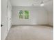 Carpeted bedroom with ample light from the window, ceiling fan, and double door closet at 12230 Asbury Park Dr, Roswell, GA 30075