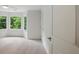 Bright bedroom with bay windows providing natural light and treetop views, enhancing the living space at 12230 Asbury Park Dr, Roswell, GA 30075
