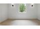 Cozy carpeted room with recessed lighting and natural light from a curved window at 12230 Asbury Park Dr, Roswell, GA 30075
