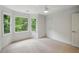 Inviting bedroom with bay windows showcasing green views, complemented by neutral carpet and trim at 12230 Asbury Park Dr, Roswell, GA 30075