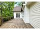 Wood deck with railing and view of green landscaping and pond in the backyard at 12230 Asbury Park Dr, Roswell, GA 30075