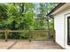 Wood deck and railing overlooking the backyard pond and landscaping at 12230 Asbury Park Dr, Roswell, GA 30075