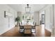 Beautiful dining room featuring hardwood floors, a modern chandelier, and a large bay window at 12230 Asbury Park Dr, Roswell, GA 30075