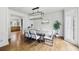 Elegant dining room with hardwood floors, modern chandelier, and view into kitchen at 12230 Asbury Park Dr, Roswell, GA 30075