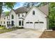 Beautiful two-story painted brick home with a two-car garage, arched windows, and well-maintained landscaping at 12230 Asbury Park Dr, Roswell, GA 30075