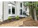 Front exterior view of the home with manicured landscaping, and a stone pathway leading to the entrance at 12230 Asbury Park Dr, Roswell, GA 30075