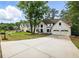 Charming two-story home with a well-kept lawn, concrete driveway, and an attached two-car garage at 12230 Asbury Park Dr, Roswell, GA 30075