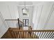 View of staircase and chandelier in foyer with an open floor plan at 12230 Asbury Park Dr, Roswell, GA 30075