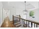 Grand foyer with a stunning chandelier, hardwood floors, and elegant staircase leading upstairs at 12230 Asbury Park Dr, Roswell, GA 30075